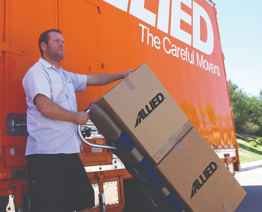 Morse-Movings-Commitment-to-the-Parma-Heights allied van line team member pushing a dolly with 3 boxes on it