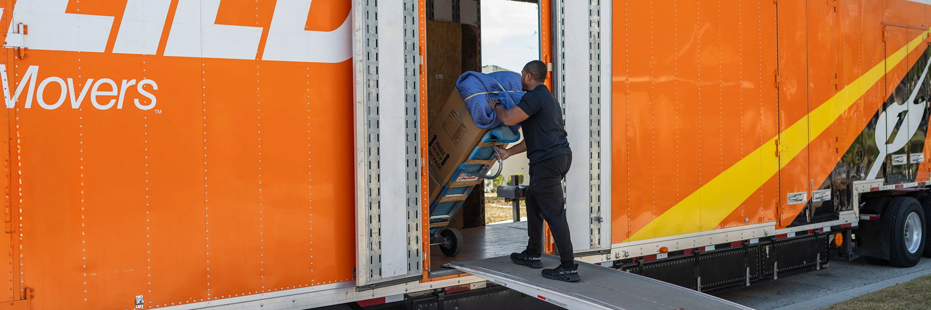Moving-Companies-Serving-Berea allied moving crew load items into a truck with a dolly